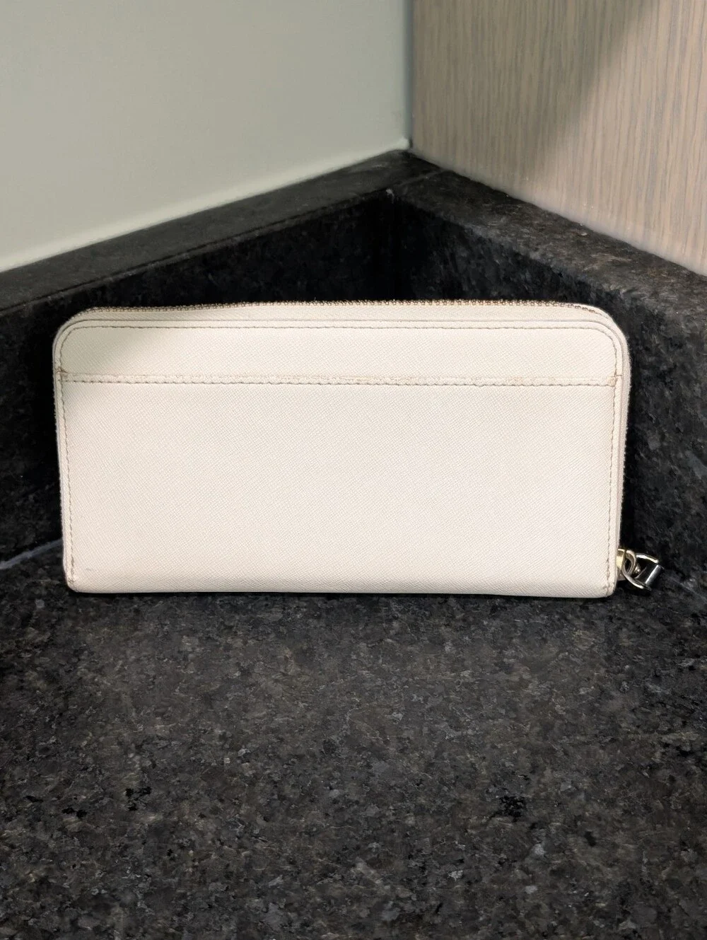 Kate Spade cream zip-around wallet with black sunglasses applique